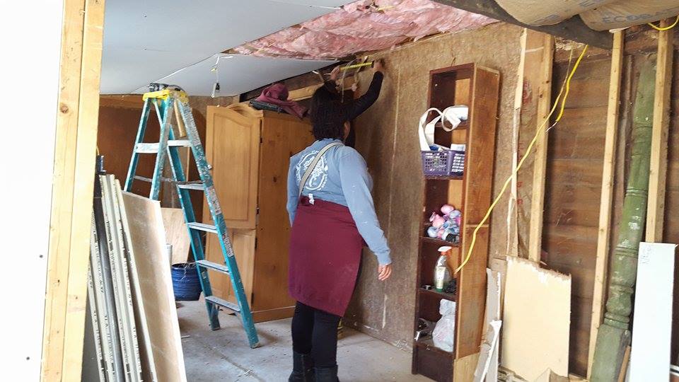 University of Richmond students installing sheetrock in Brandi Wright's old cabin at Berwind Lake. The cabin was built in 1856