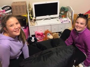 Two Appalachian girls with new home computer helping bridge the digital divide.