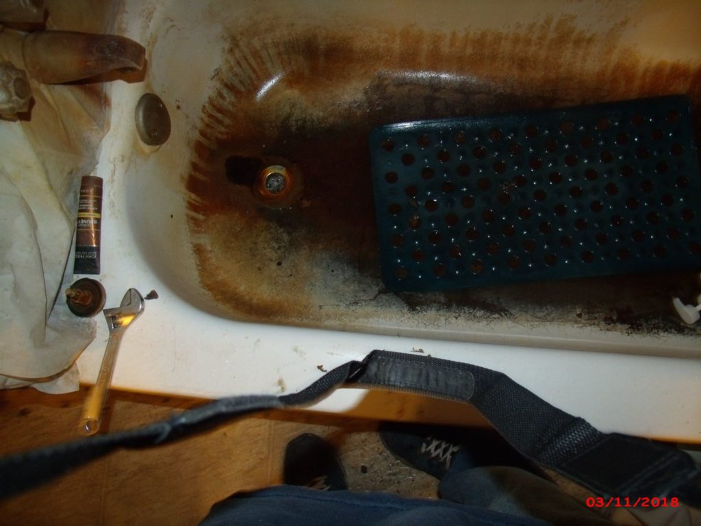 Heavily stained bathtub in West Virginia home before Americans Helping Americans bathroom upgrade.