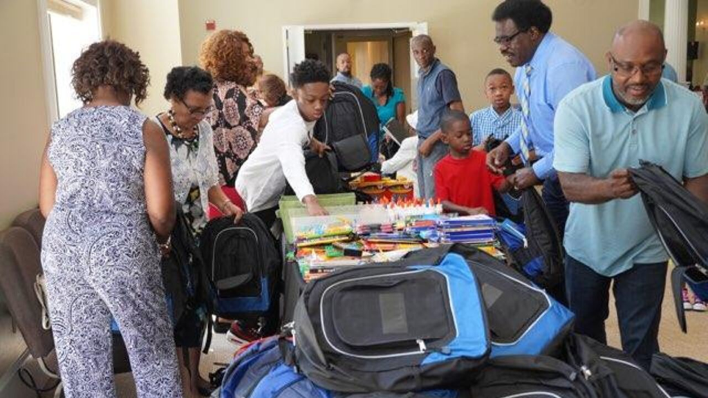 Giving out school supplies and backpacks