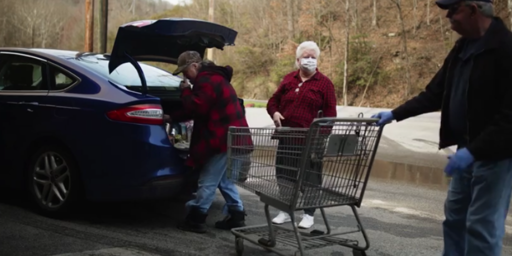 1 (4) Volunteers load groceries into a car while helping Appalachian families during the COVID-19 pandemic