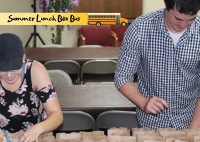 Volunteers pack bag lunches for the Of One Accord program to feed hungry children in rural Tennessee during the summer.