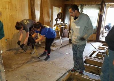 Volunteers perform interior home repairs for a low-income family in Appalachia supported by Americans Helping Americans.