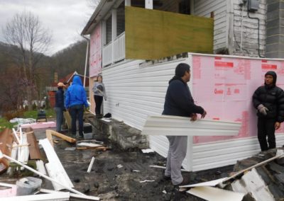 Ocoee Outreach volunteers install new siding to repair a tornado-damaged home in Cleveland, Tennessee.