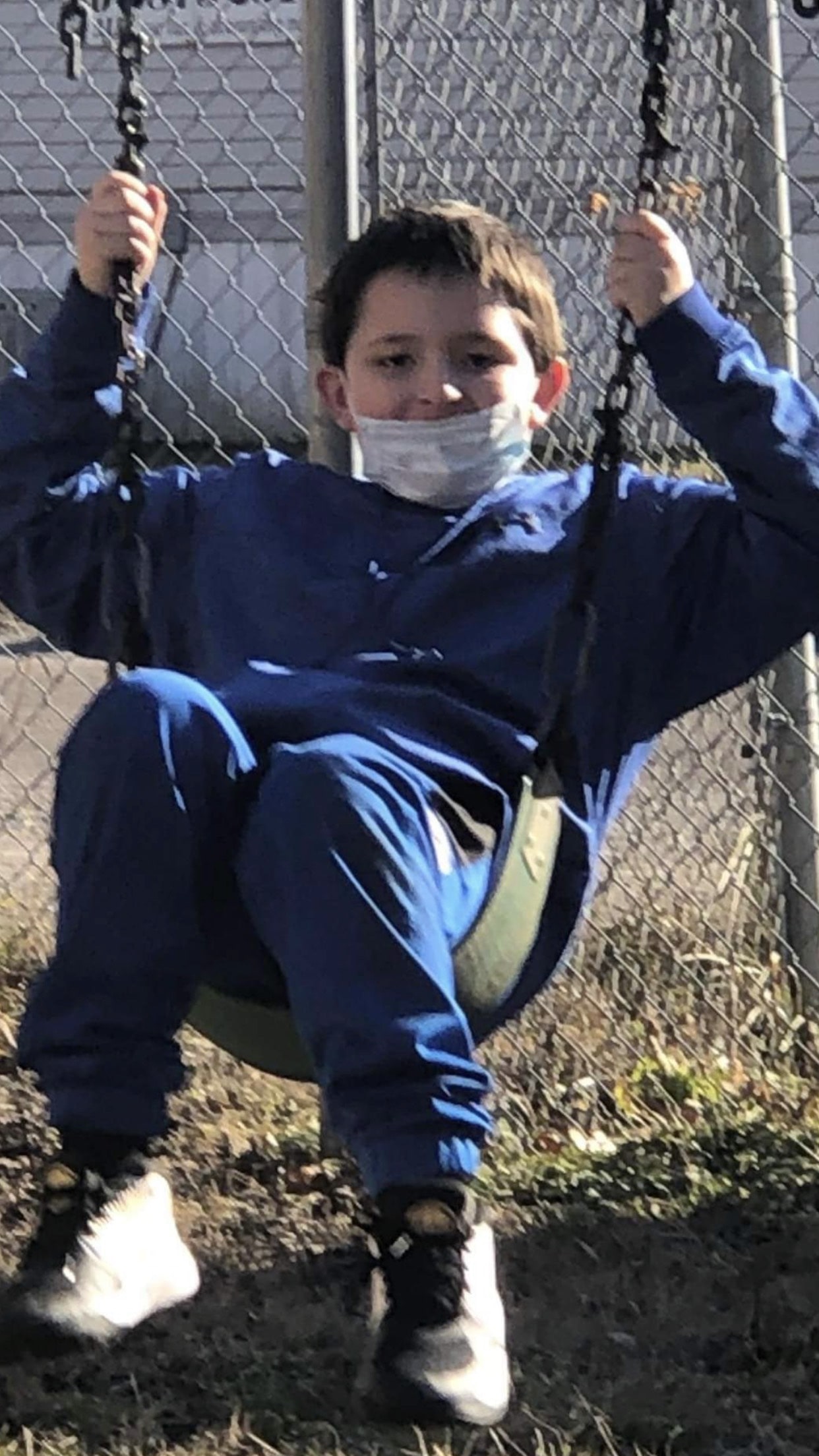 Jayce, an elementary student in the Big Creek People in Action afterschool program, playing outdoors in McDowell County.