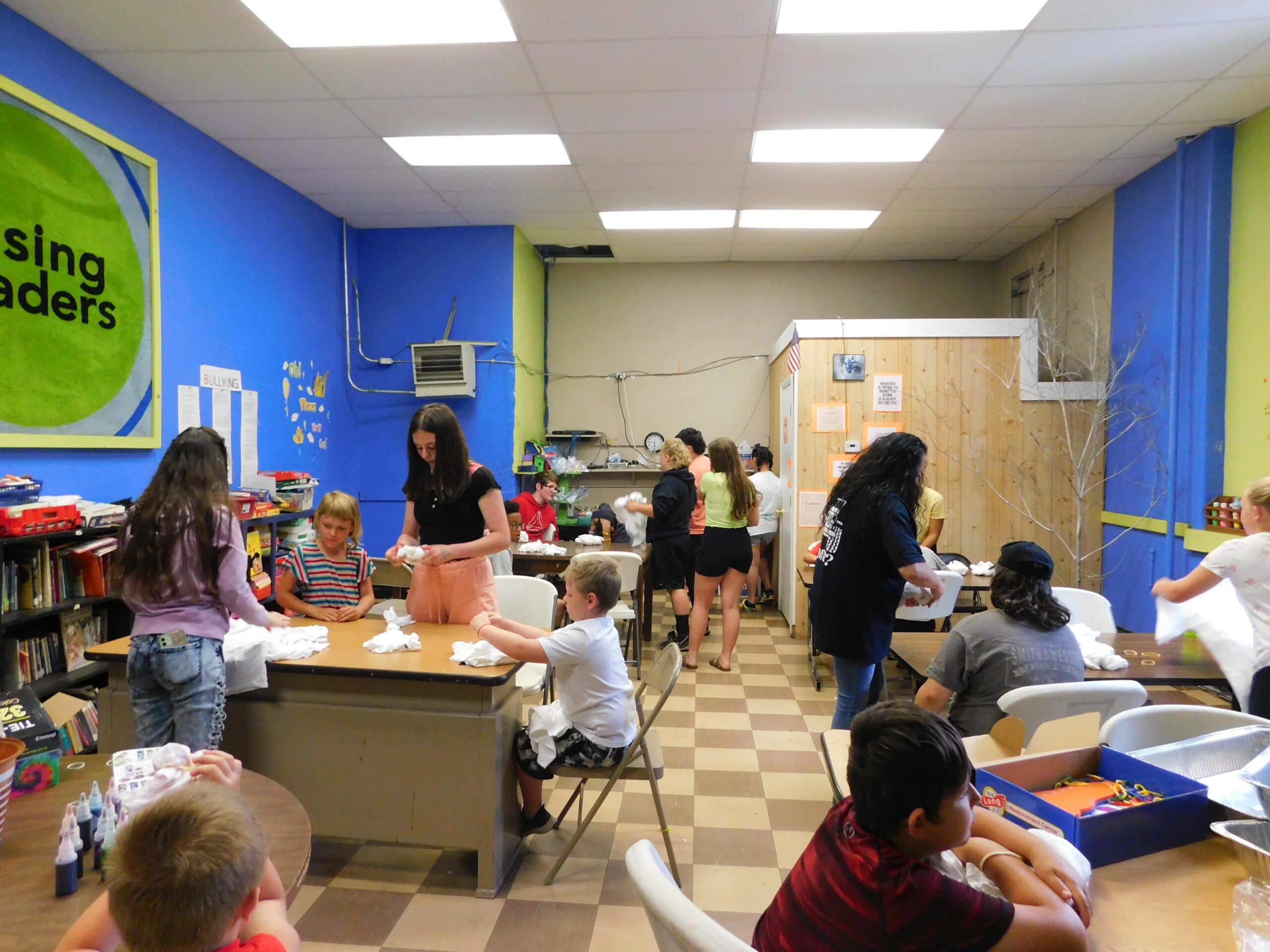 Students gathering at the BCPIA center to prepare T-shirts for tie-dying during summer camp.