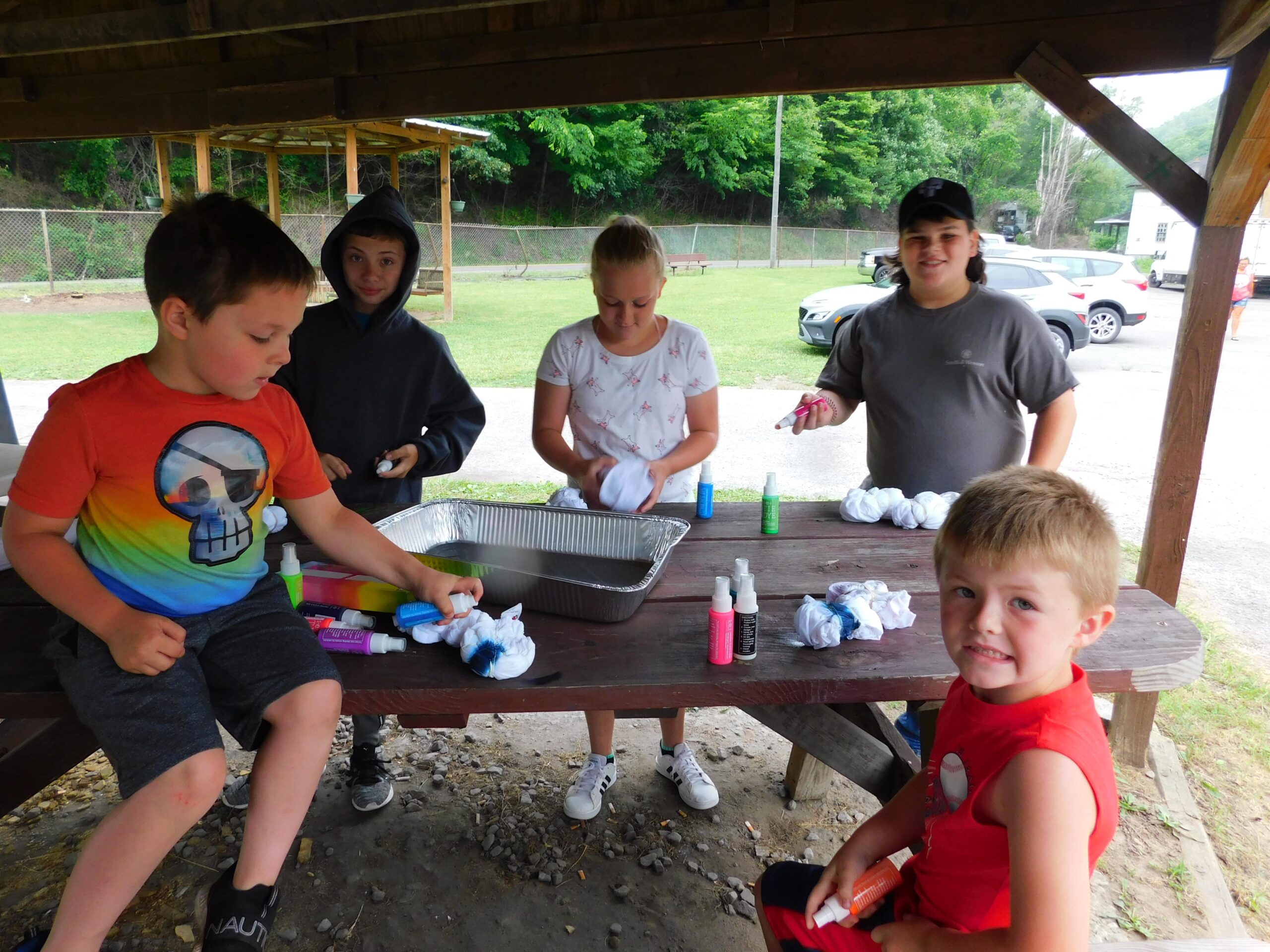 Summer campers tie-dying T-shirts and socks as part of arts and crafts activities in West Virginia.