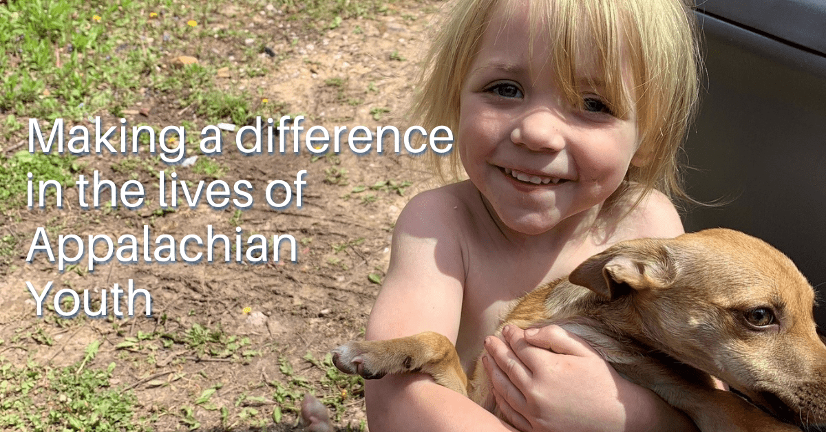 Smiling Appalachian child holding puppy
