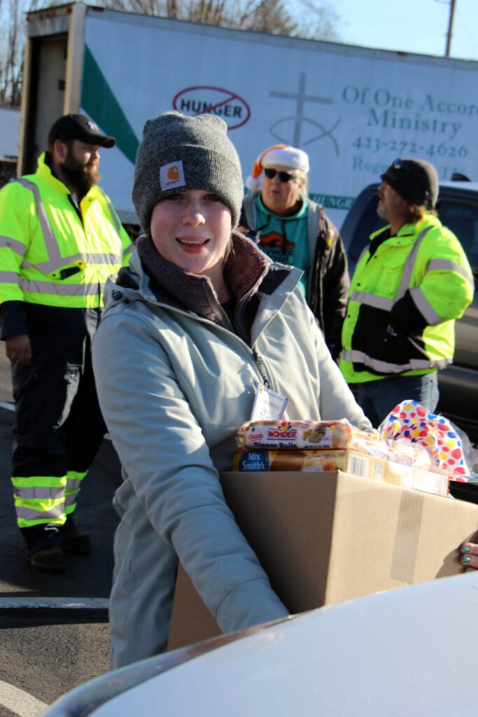 Appalachian woman receiving donated food box during community distribution event