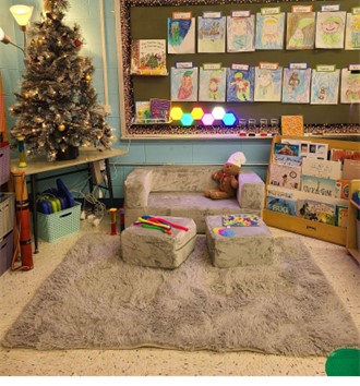A calm down corner in a Tennessee classroom featuring a shaggy rug, bean bag chairs, and sensory lighting.