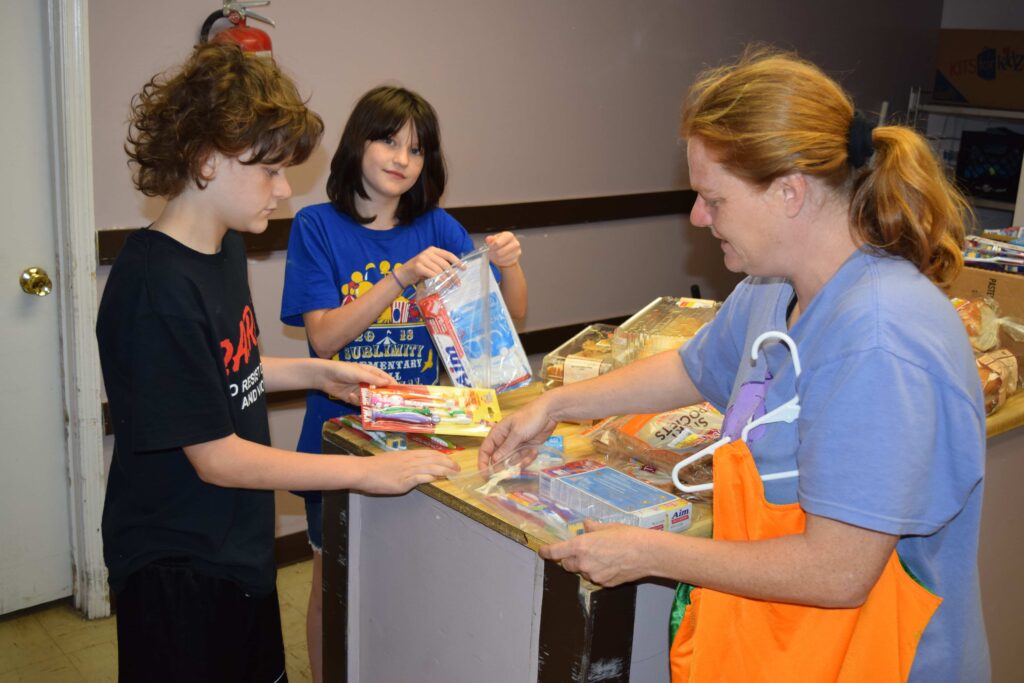 Volunteers distribute dental hygiene kits with toothbrushes and toothpaste to children in McDowell County, West Virginia.