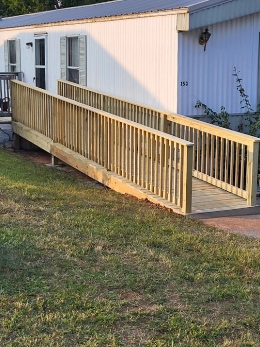 A new handicap ramp at a mobile home in Tennessee, constructed at no cost by AMOS and Americans Helping Americans.