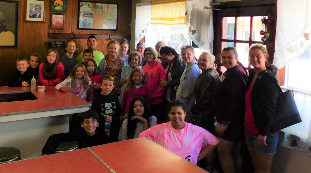 Group of Appalachian children and mentors enjoying summer camp outing supported by Americans Helping Americans®