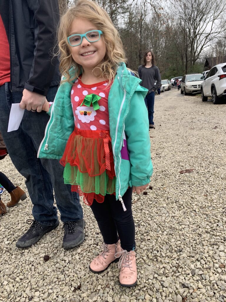 A young girl in Beattyville, Kentucky, enjoys holiday activities at a community Christmas party.