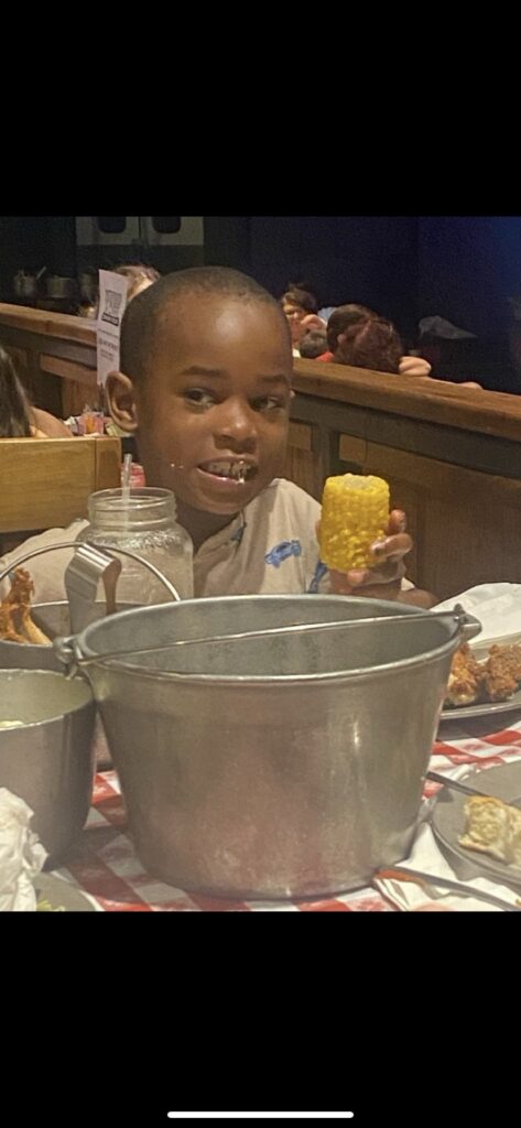 A young camper enjoys a fresh meal of corn on the cob during a group dinner show in Pigeon Forge, Tennessee.