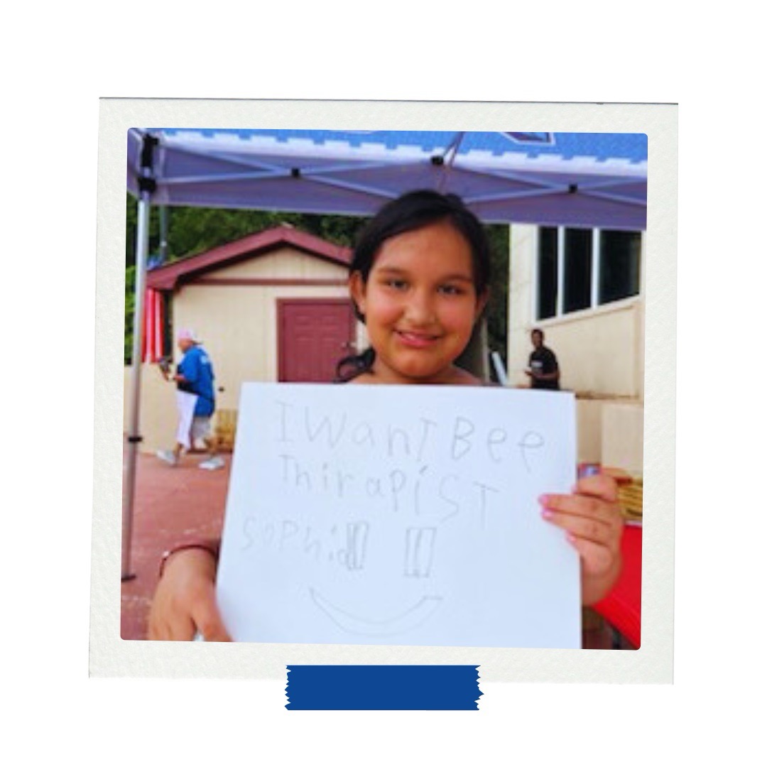 LAMP afterschool student holds vision board stating she wants to be a therapist.