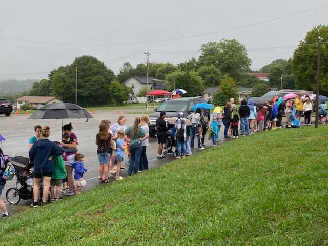 Families in Jefferson City, TN wait in the rain for the AMOS Back to School Bash and food box distribution.