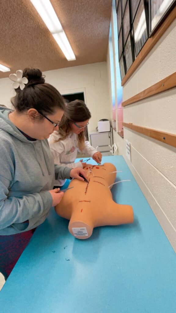 Appalachian nursing students practicing sutures in hands-on training with Want2Work program support