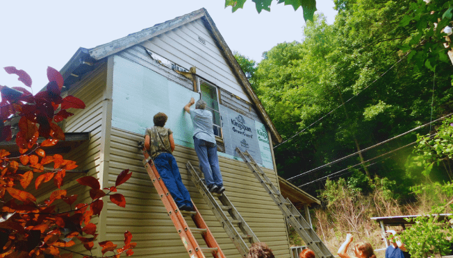 Volunteers repairing Appalachian home with new siding and insulation