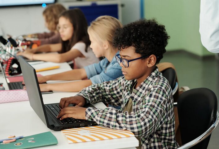 A young student in Appalachia uses a laptop provided by Americans Helping Americans to bridge the digital divide.