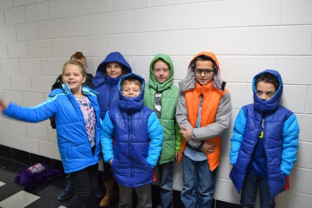 Children receiving warm coats through the basic needs assistance program.