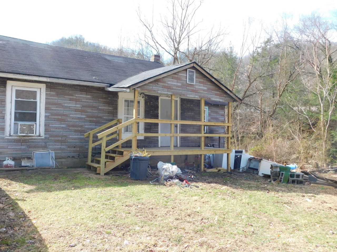 AHA Housing Santana’s house Large Repaired Appalachian home with a newly built front porch and steps after community-led housing repairs.