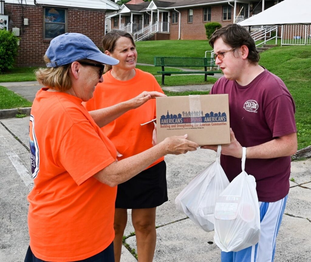 Pam and AMOS volunteer deliver an Americans Helping Americans food box to a community member in Tennessee.