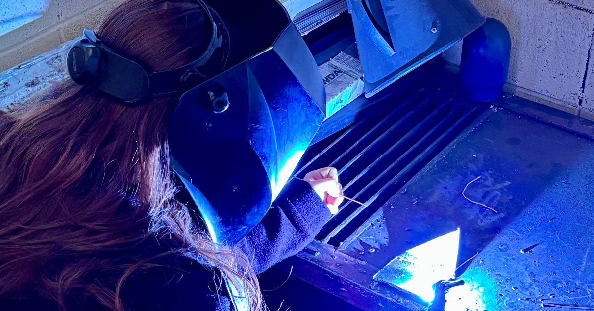 Want2Work Welding Student Building Skills Through Hands-On Training Student welding during hands-on training through the Want2Work program while wearing a protective welding helmet