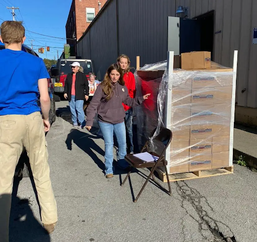 Volunteers unloading emergency relief boxes.
