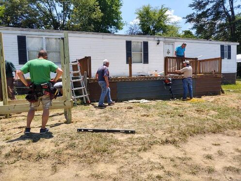 Appalachian Outreach Ministry building a wooden deck and wheelchair ramp at a home repair project in Jefferson City, Tennessee.