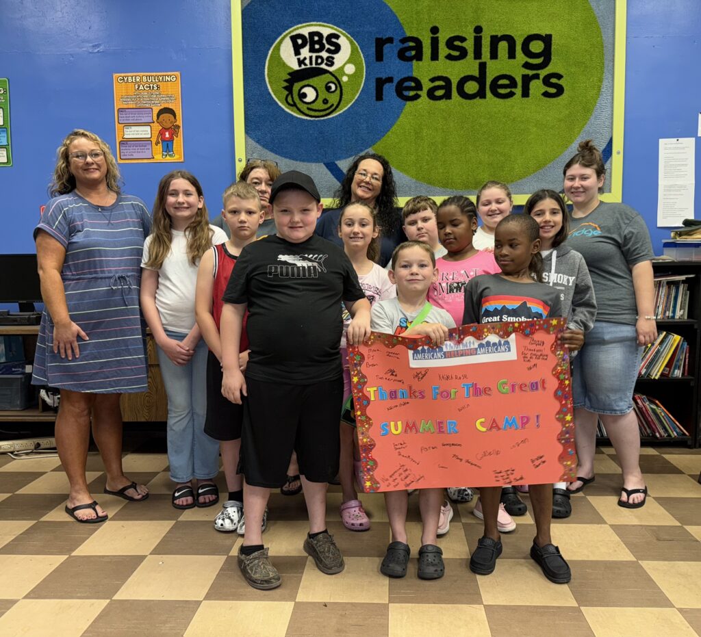 Children and staff at Big Creek People in Action holding a thank you sign at summer camp in War, West Virginia.