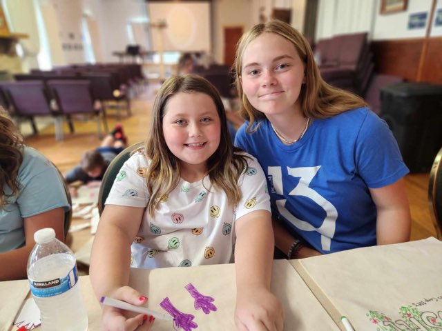 Youth participants smiling during a Cumberland Mountain Outreach arts and crafts activity in Beattyville, Kentucky.